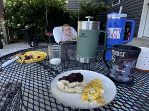 Breakfast this morning on the porch. Eggs, yogurt biscuits, and fresh blackberry jam